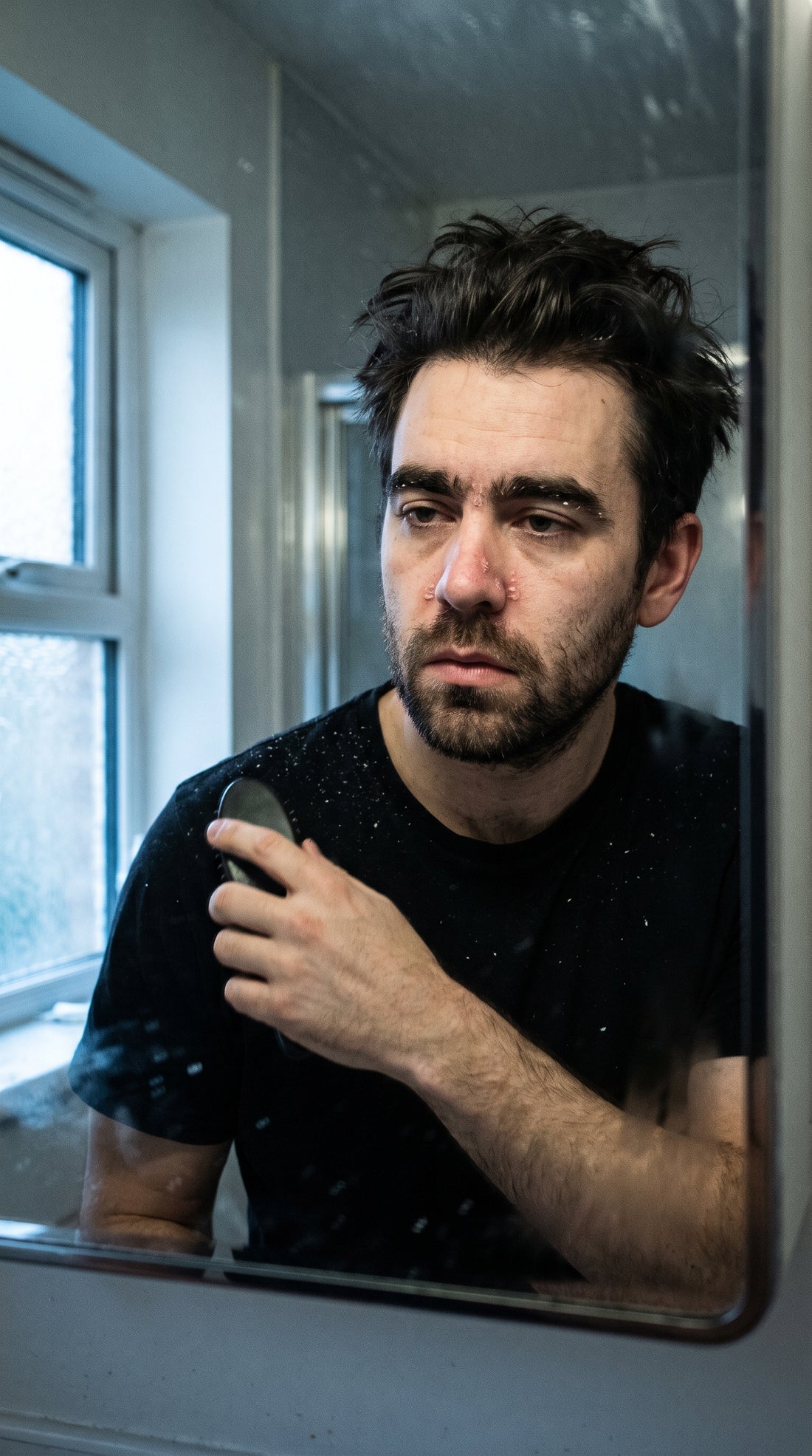 Flakes on a black t-shirt, in the eyebrows and beside the nose